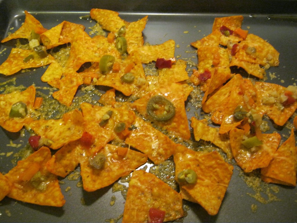 Melted cheddar cheese over hot peppers and Doritos.