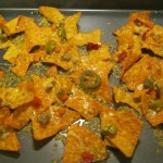 Melted cheddar cheese over hot peppers and Doritos.