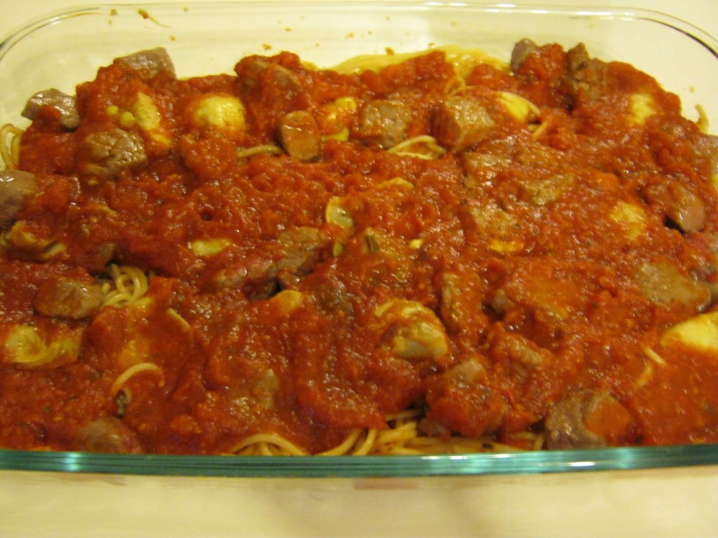 Marinara sauce over steak, artichoke hearts and spaghetti.