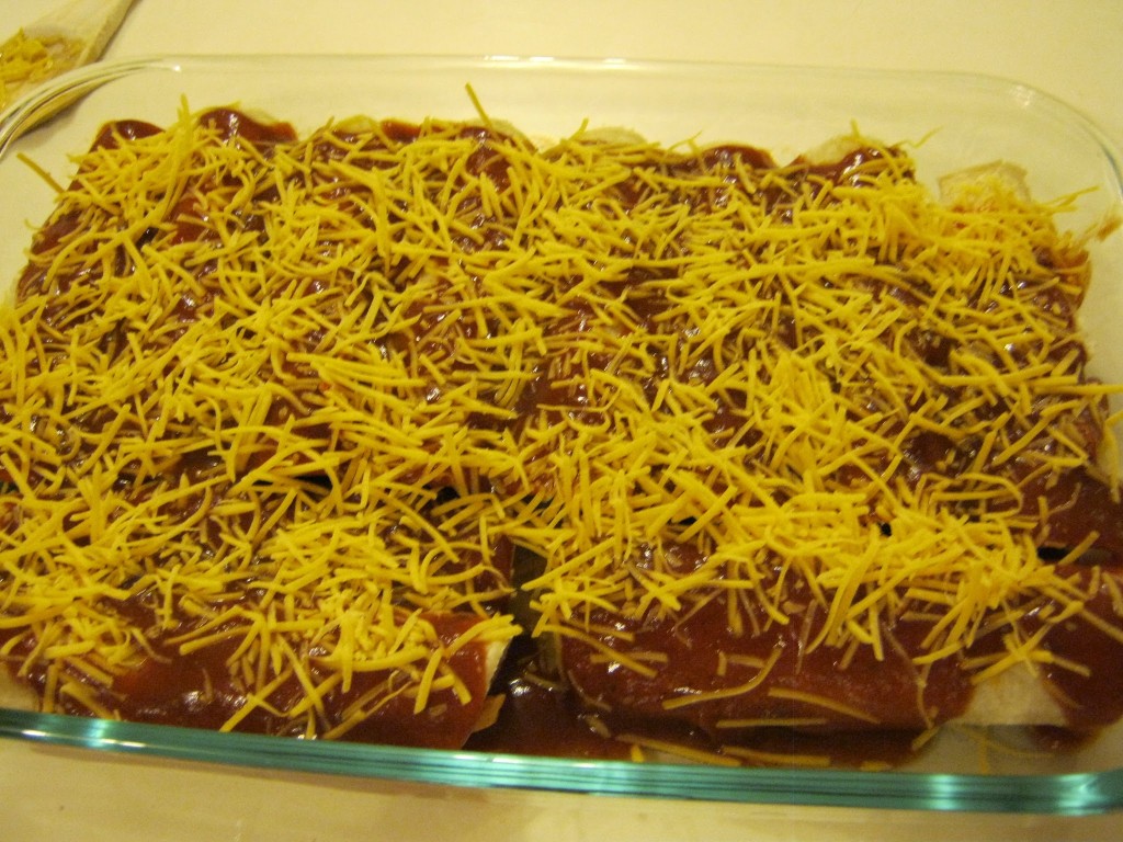 Enchiladas sprinkled with cheese and ready to cook