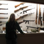 guns on the wall in cases